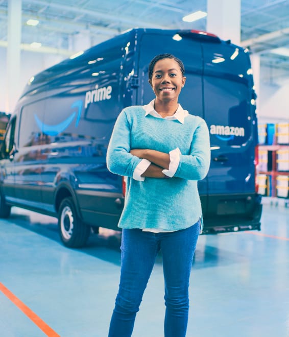 Delivery driver holding package in front of delivery van
